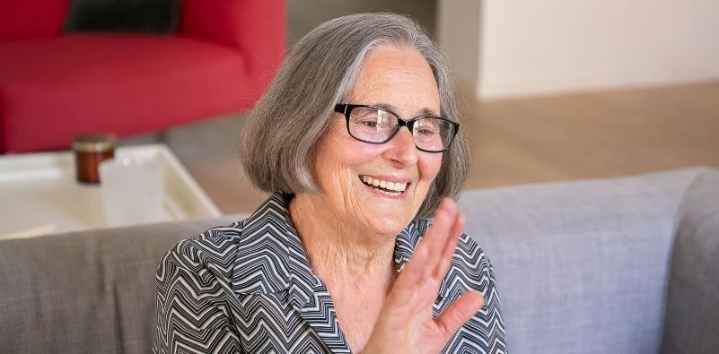 A woman looking happy wearing glasses.